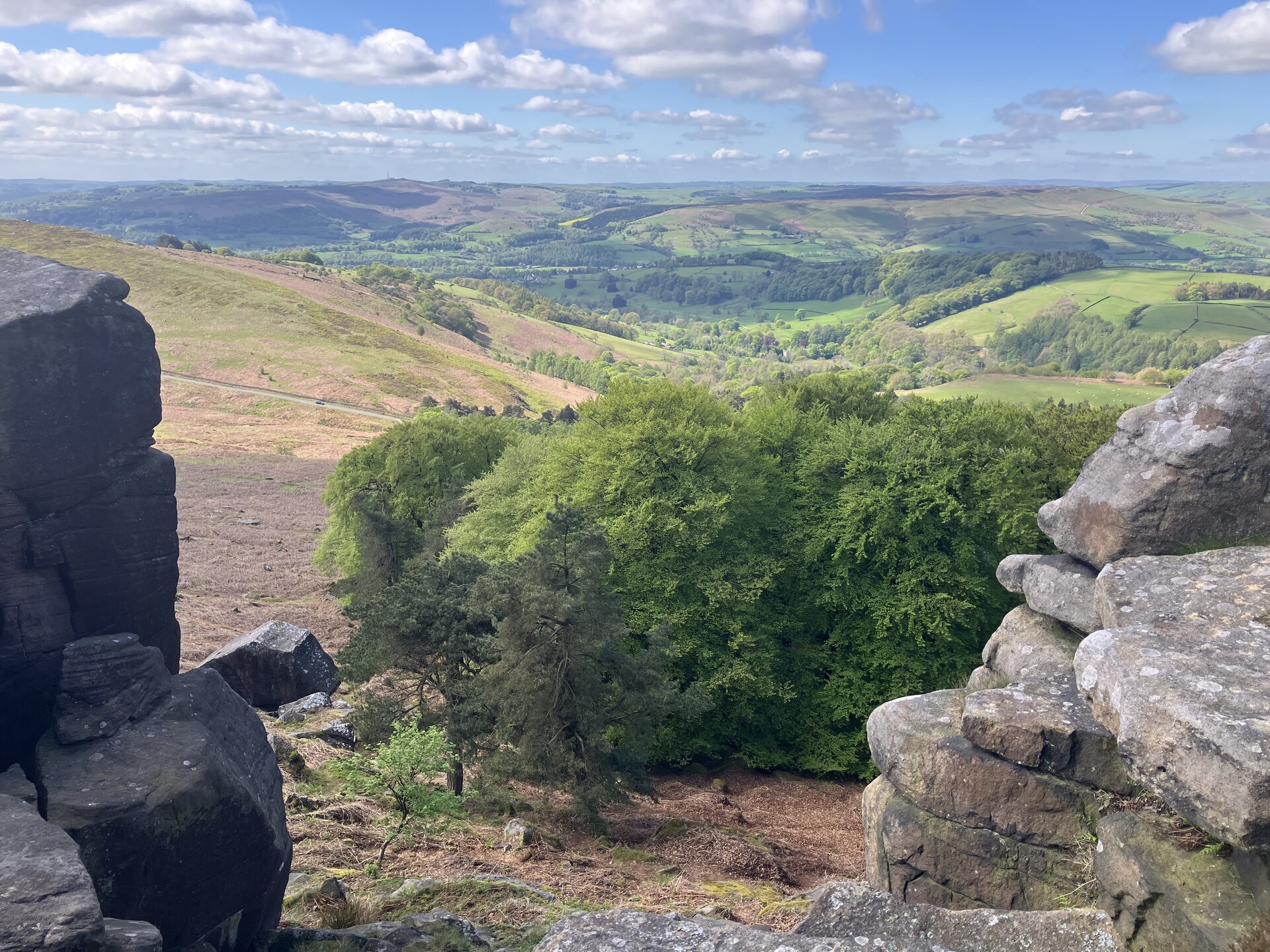 View through the rocks at Stanage Edge over the valley