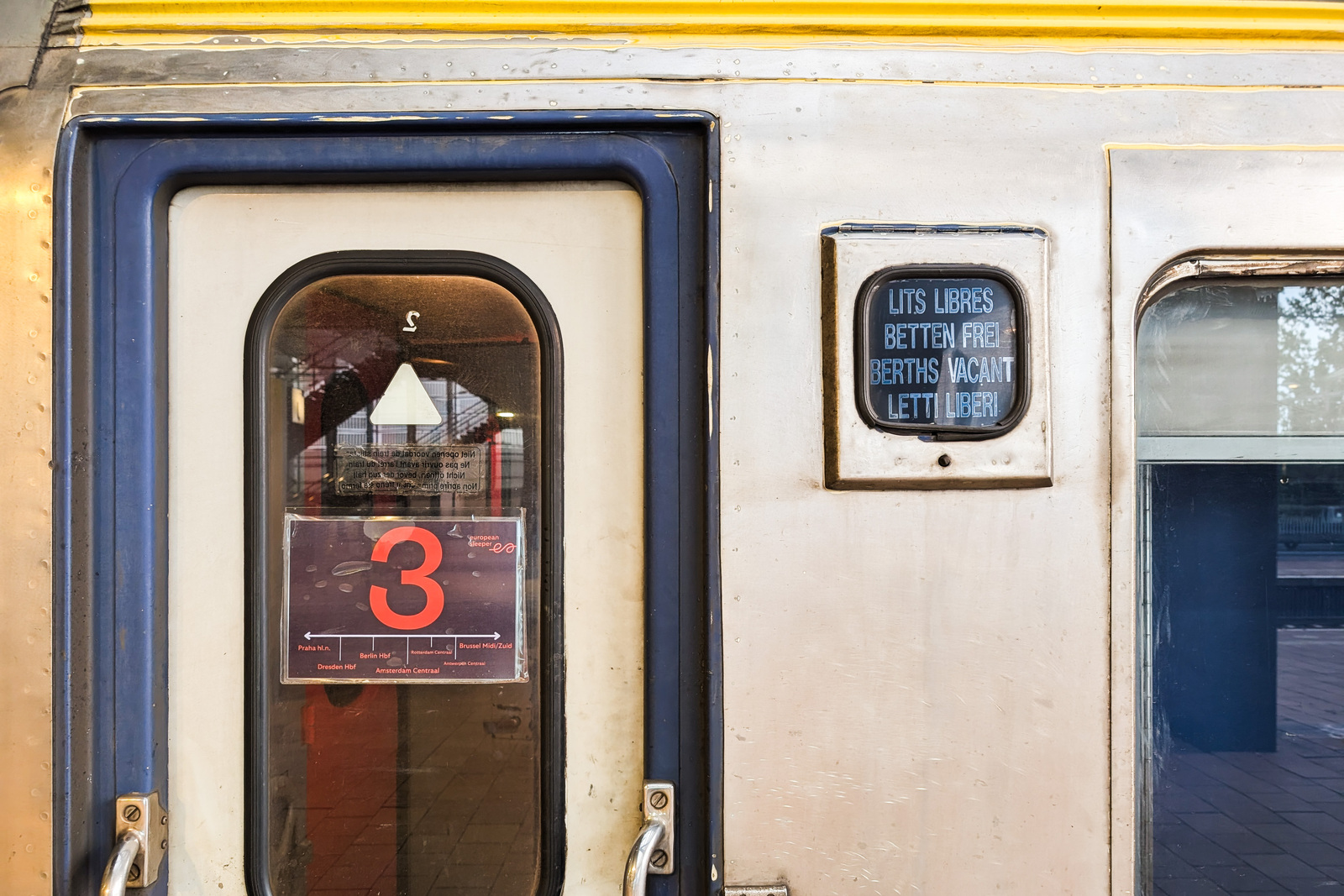 Brussels to Berlin & Prague by Night Train: What It's Really Like European Sleeper carriage door showing the Prague-Berlin-Amsterdam-Brussels route