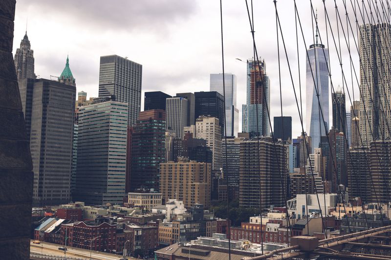 Lower Manhattan towers viewed through Brooklyn Bridge cables