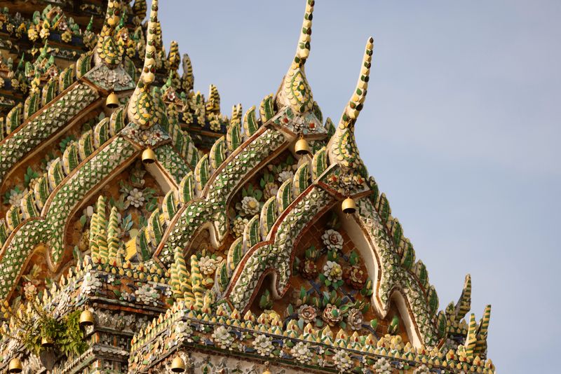 Close-up of ornate green and gold temple roof finials