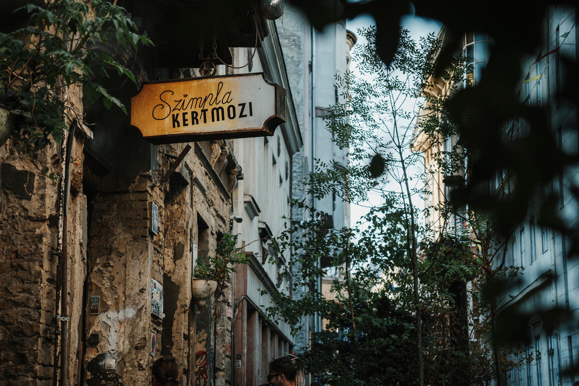 Szimpla Kertmozi sign hanging above ruin bar alley entrance