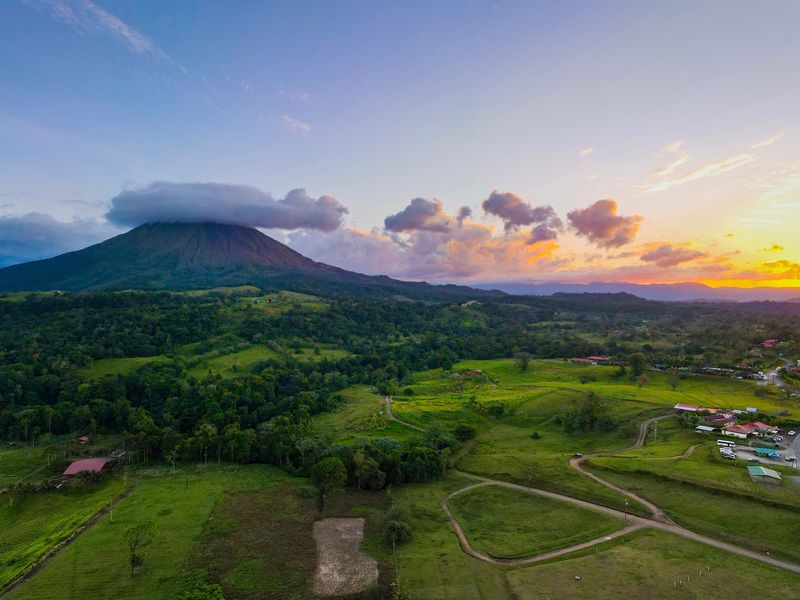 Aerial view of volcano and valley at colorful sunset