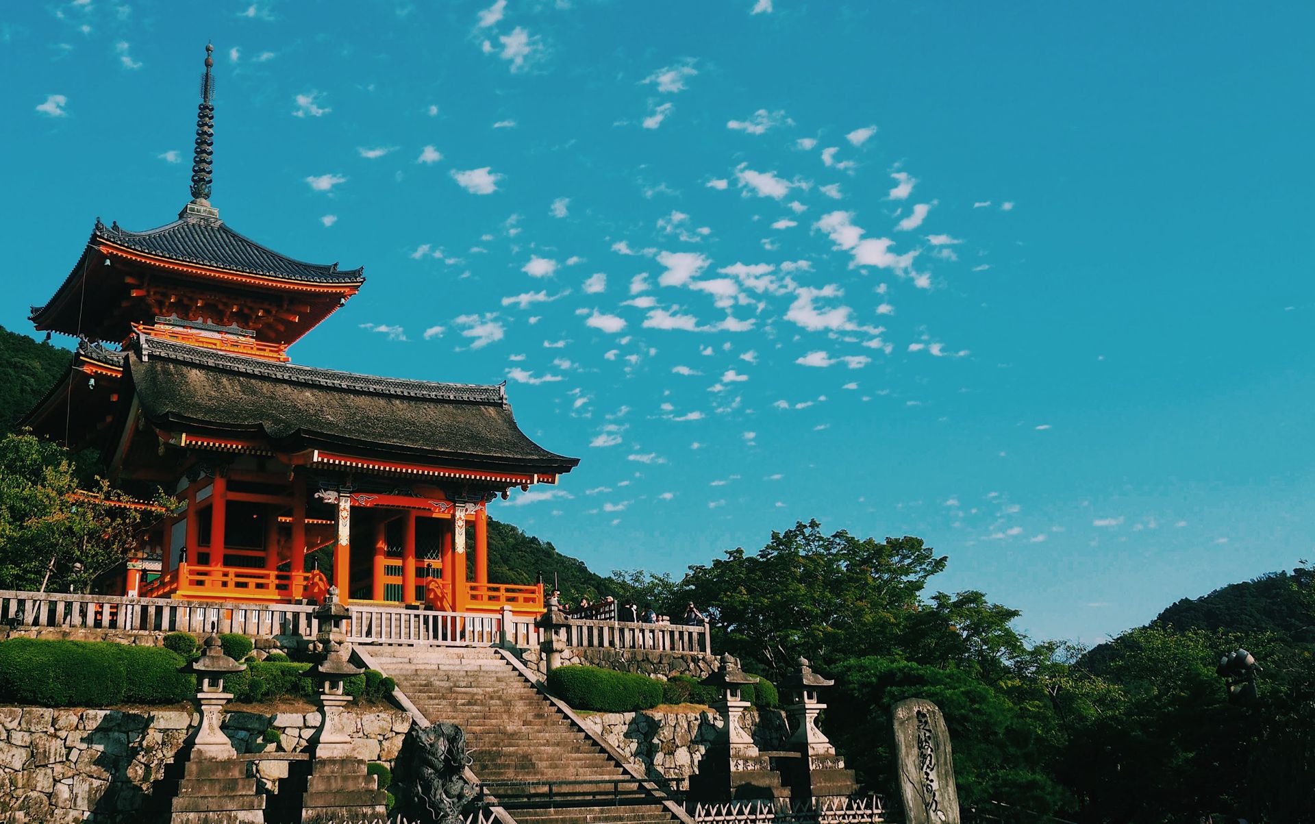 Kiyomizu-dera's orange pagoda against blue sky with clouds