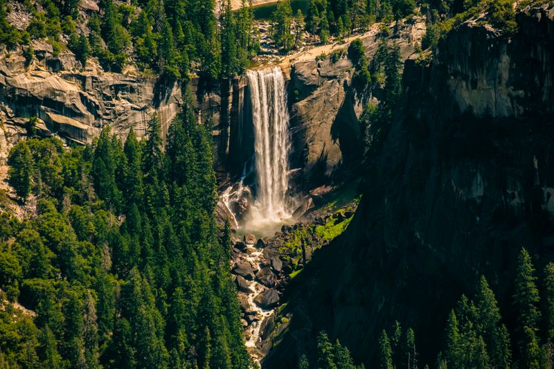 Yosemite's Hidden Waterfall Trails: Why a Private Guide Is Worth It Vernal Fall plunging over rock face surrounded by forest