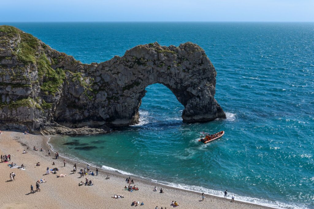 Durdle Door limestone arch on the Jurassic Coast, Dorset, under a clear blue sky