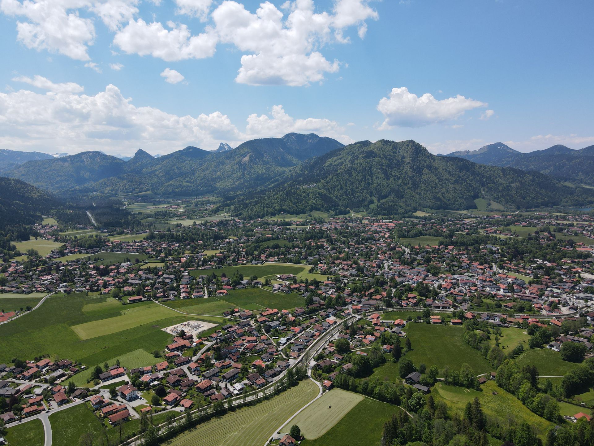 Aerial view of Bavarian village nestled among green mountains