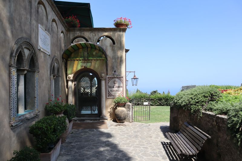 Entrance archway of a hillside villa hotel with sea view
