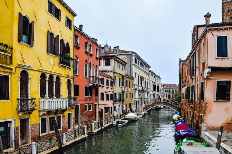 Colorful yellow and red buildings along a quiet canal